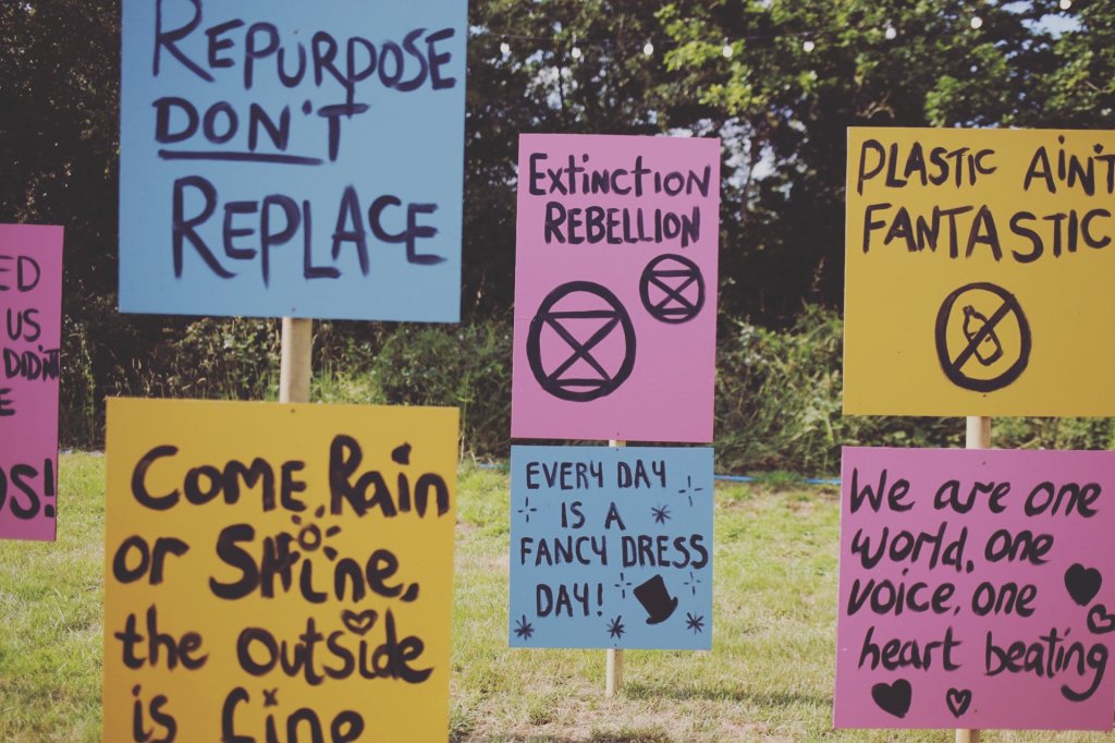 A series of coloured wooden boards with handwritten messages.